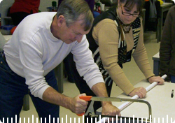 2 teachers cutting a PVC pipe