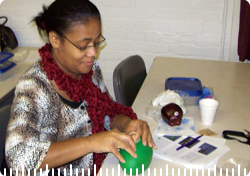 A woman performing an experiment with a green balloon